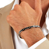 Ανδρικό βραχιόλι Maserati JM423ATZ30 από ανοξείδωτο ατσάλι και κεραμικό, με ασημί-μαύρο χρώμα και χρυσά στοιχεία-φορεμένο.