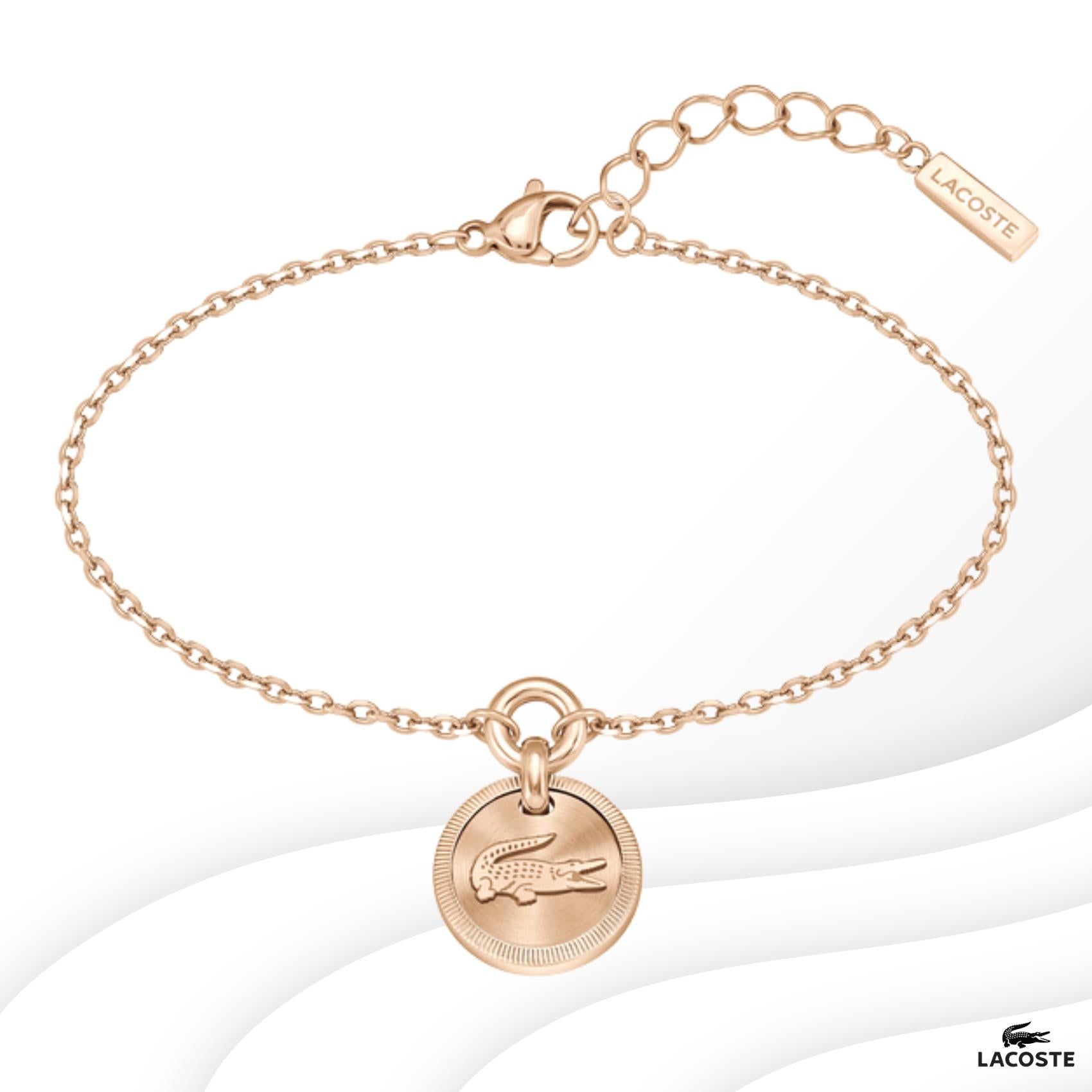 Ατσάλινο βραχιόλι Lacoste 2040405 σε ροζ χρυσό χρώμα με στρογγυλό κρεμαστό στοιχείο και ρυθμιζόμενο κούμπωμα από ανοξείδωτο ατσάλι.