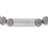 Ανδρικό βραχιόλι Calvin Klein 35000427 με χάντρες ίασπις σε γκρι χρώμα διακοσμημένο με κυλινδρικό στοιχείο από ανοξείδωτο ατσάλι σε ασημί χρώμα.