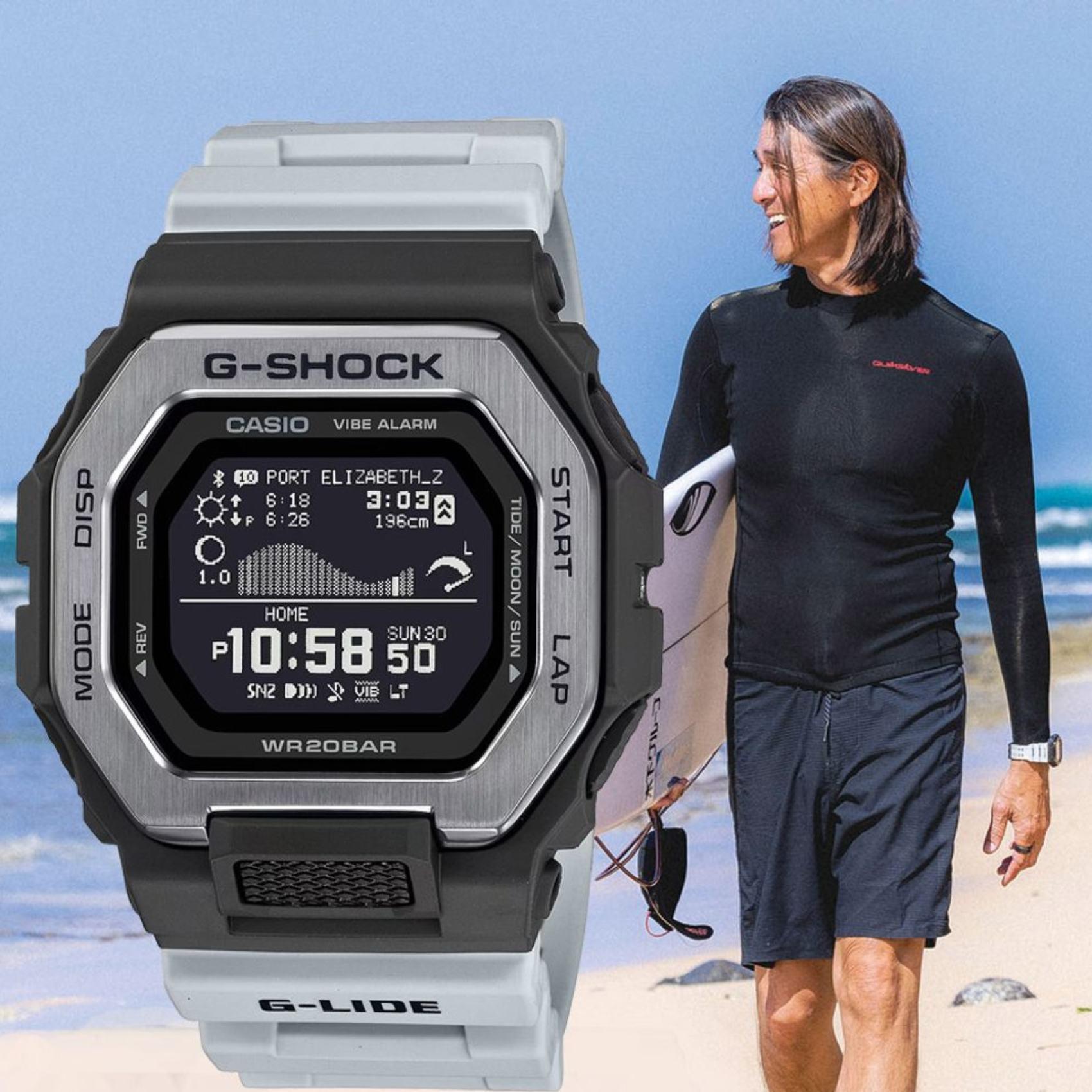 Ρολόι με λειτουργίες προπόνησης Casio G-Lide G-Shock GBX-100TT-8ER με γκρι καουτσούκ λουράκι και μαύρο καντράν διαμέτρου 46mm σε τετράγωνο σχημα.