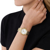 Γυναικείο ρολόι Michael Kors Lennox MK7278 με χρυσό ατσάλινο μπρασελέ, άσπρο καντράν και στρογγυλό στεφάνι 32mm με ζιργκόν.