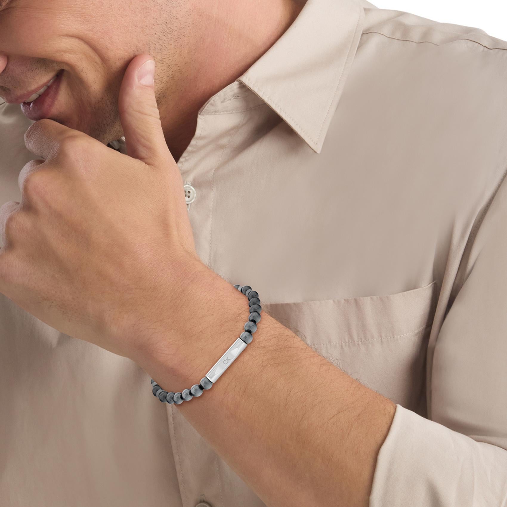 Ανδρικό βραχιόλι Calvin Klein 35000575 με γκρι χάντρες, διακοσμημένο με ασημί στοιχείο από ανοξείδωτο ατσάλι.