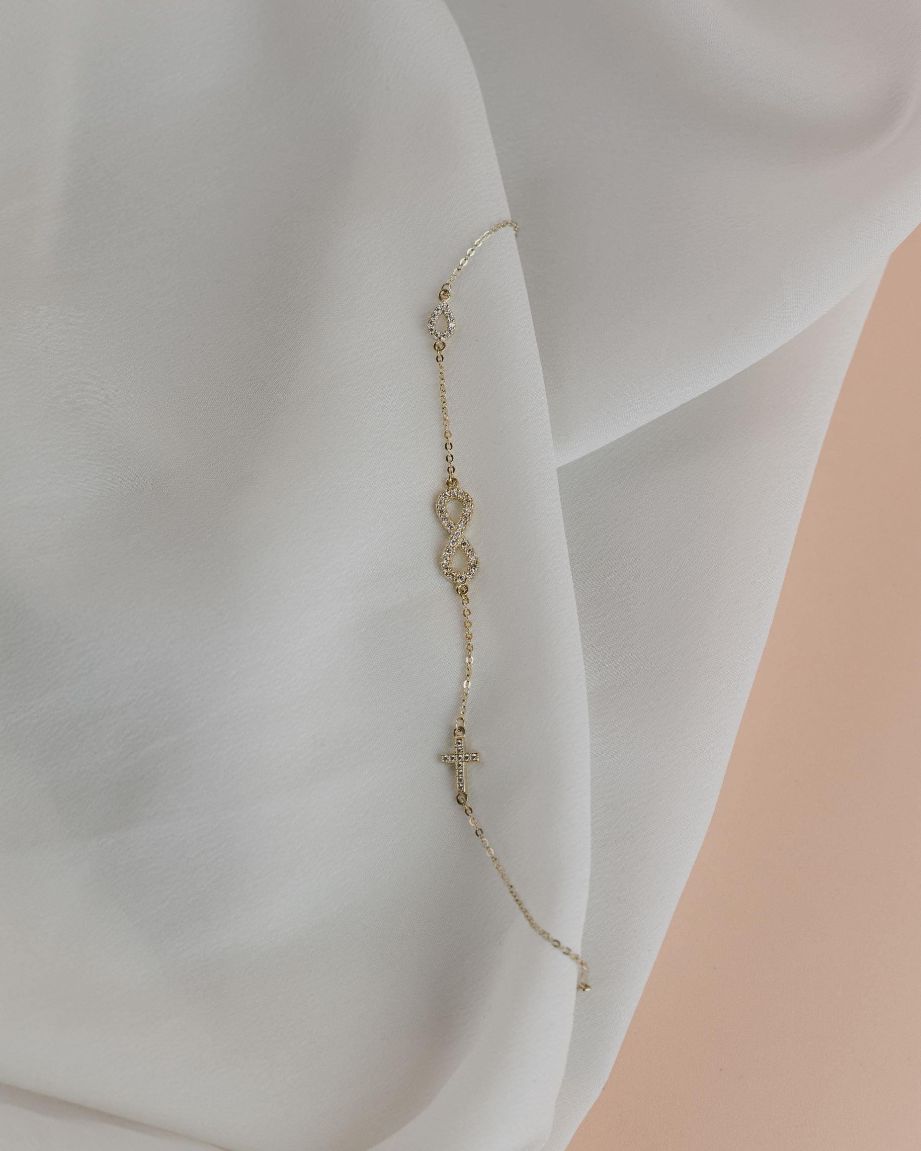 Βραχιόλι χρυσό με άπειρο και σταυρό BT5102.009