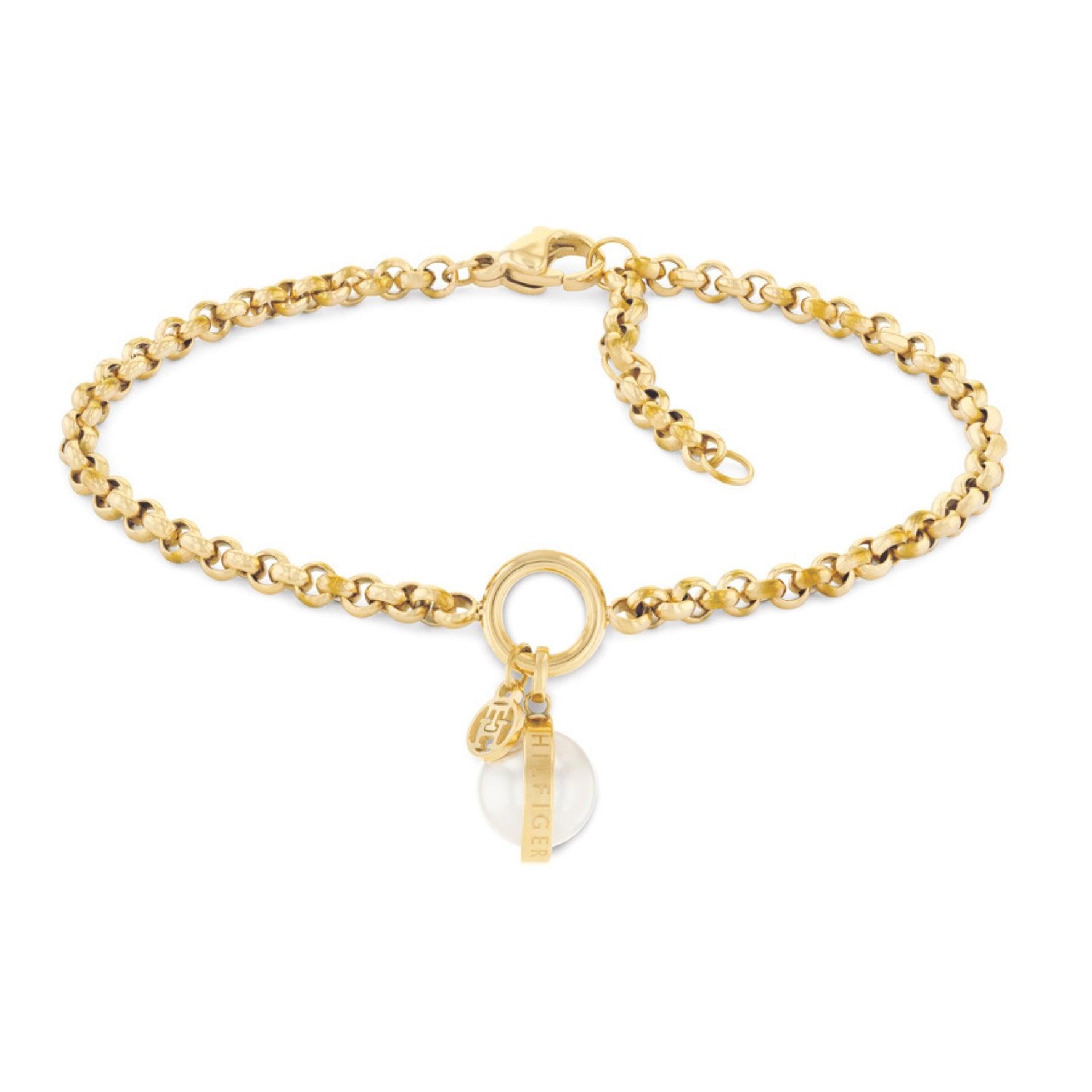 Γυναικείο βραχιόλι σε χρυσό χρώμα και κρεμαστό στοιχείο από λευκό φίλντισι της Tommy Hilfiger.