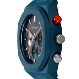 Κοντινό στο ματ μπλε καντράν του D1 Milano D1-PHBJ09 με soleil subdials και πορτοκαλί λεπτομέρειες.