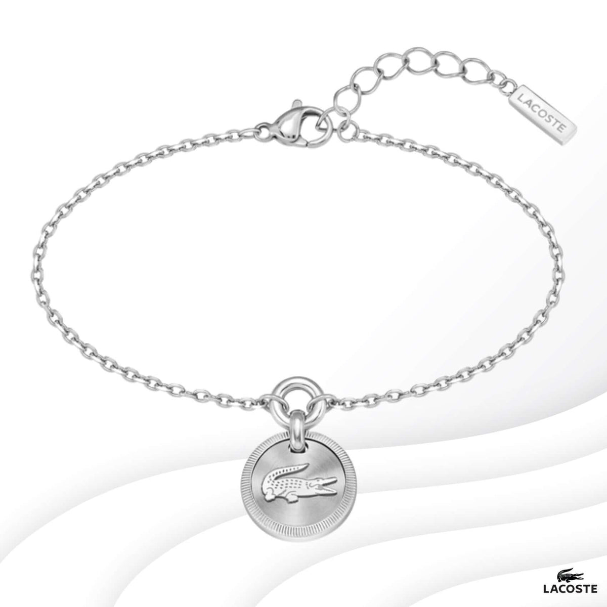Ατσάλινο βραχιόλι Lacoste 2040404 σε ασημί χρώμα με στρογγυλό κρεμαστό στοιχείο και ρυθμιζόμενο κούμπωμα από ανοξείδωτο ατσάλι.