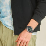 Ρολόι χρονογράφος Casio G-Shock GM-2100B-3AER με χακί καουτσούκ λουράκι, χακί καντράν μεγέθους 44.4mm anadigi κατάλληλο για καταδύσεις.