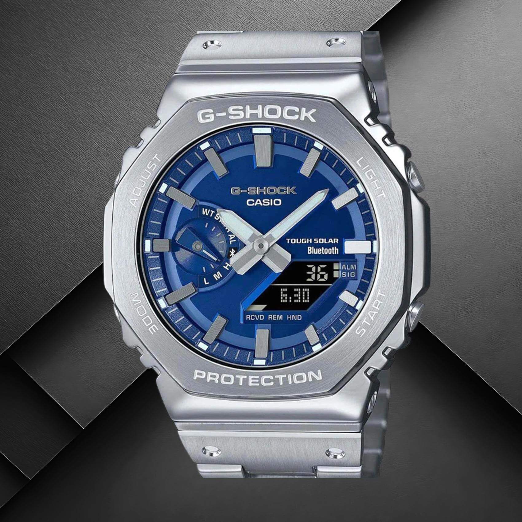 Ανδρικό ρολόι Casio G-SHOCK GM-B2100AD-2AER με ασημί ατσάλινο μπρασελέ και μπλε καντράν.