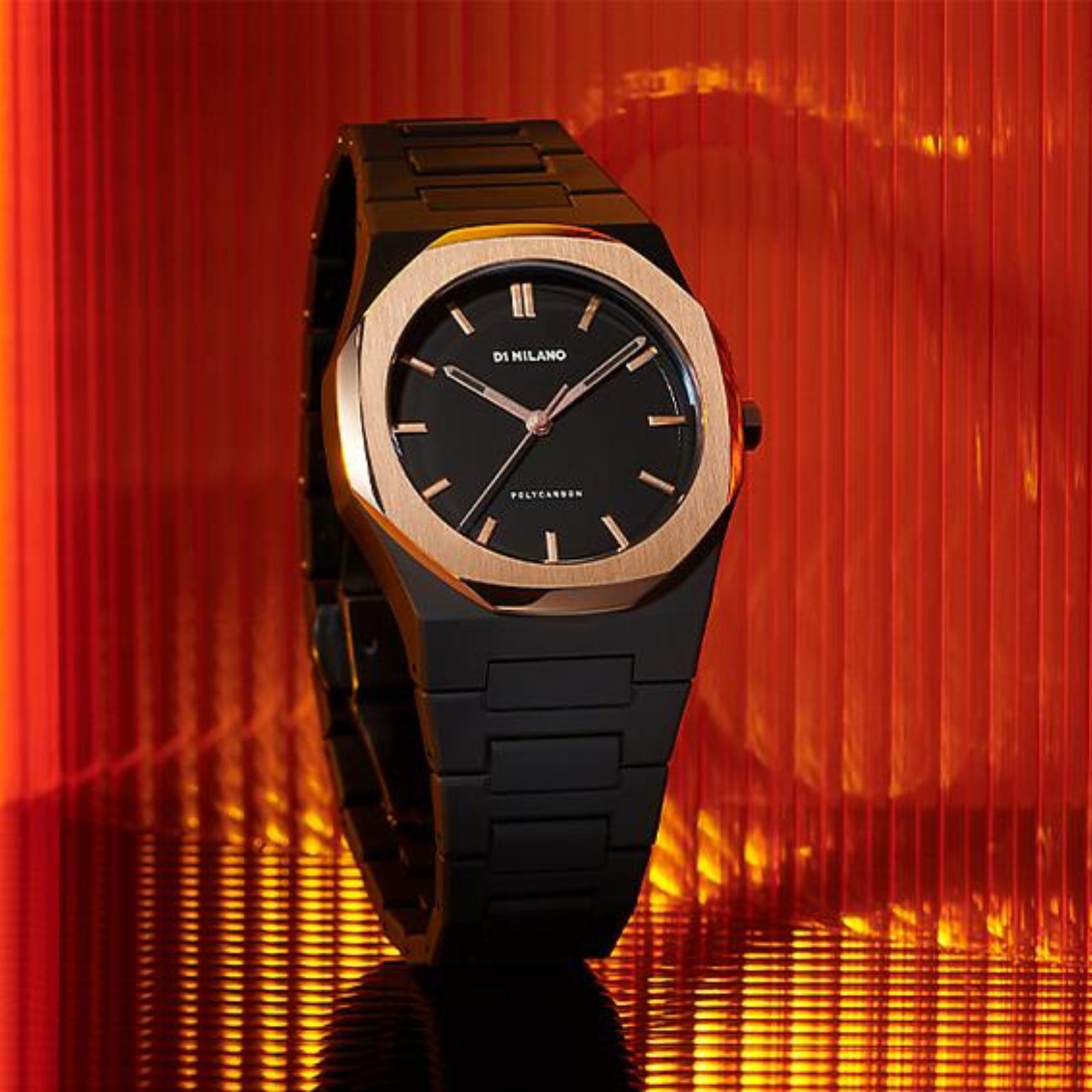 Ρολόι D1 Milano D1-PCBJ15 gloaming, με μαύρο μπρασελέ από πολυκαρμπονικό, μαύρο καντράν με ροζ χρυσές λεπτομέρειες και οκτάγωνο στεφάνι διαμέτρου 40.5 mm.