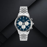 Daniel Wellington DW00100874 ανδρικό ρολόι με ασημί ατσάλινο μπρασελέ, μπλε καντράν διαμέτρου 42mm και ασημί λεπτομέρειες.