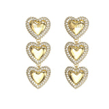Γυναικεία σκουλαρίκια Guess Beloved JUBE06011JWYGT/U από ανοξείδωτο ατσάλι σε χρυσό χρώμα με καρδιές και ζιργκόν.