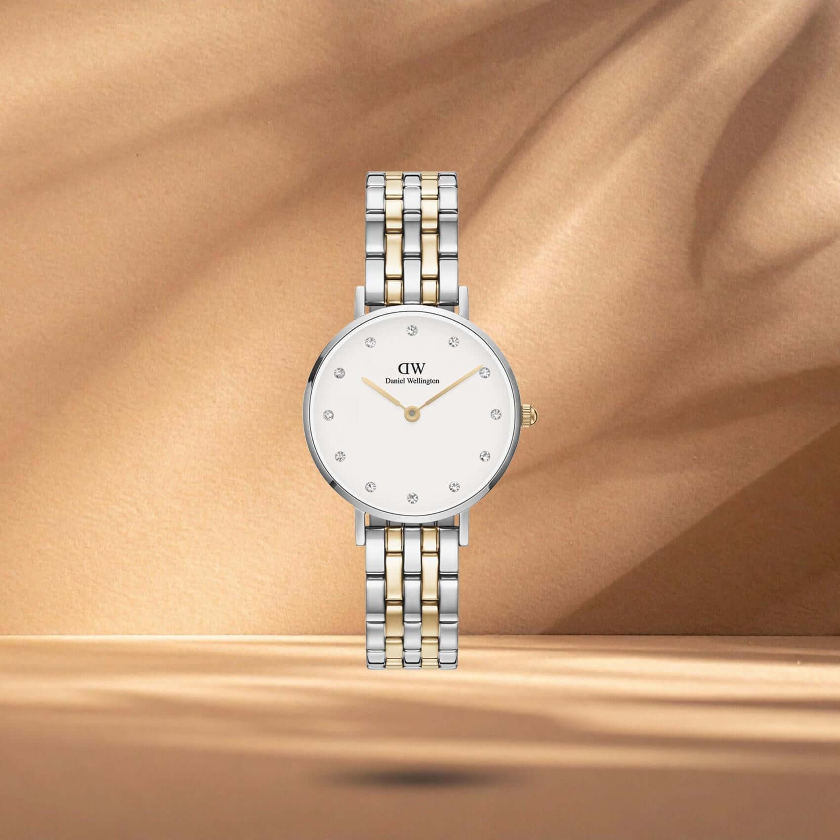 Γυναικείο ρολόι Daniel Wellington Petite Lumine DW00100616 με δίχρωμο μπρασελέ σε ασημί-χρυσό χρώμα από ανοξείδωτο ατσάλι, λευκό στρογγυλό καντράν διαμέτρου 28mm και χρυσούς δείκτες.