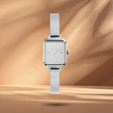 Γυναικείο ρολόι Daniel Wellington Quadro Mini Reflection DW00100800 με ασημί ατσάλινο μπρασελέ και ασημί τετράγωνο καντράν διαμέτρου 15.4x18.2mm.