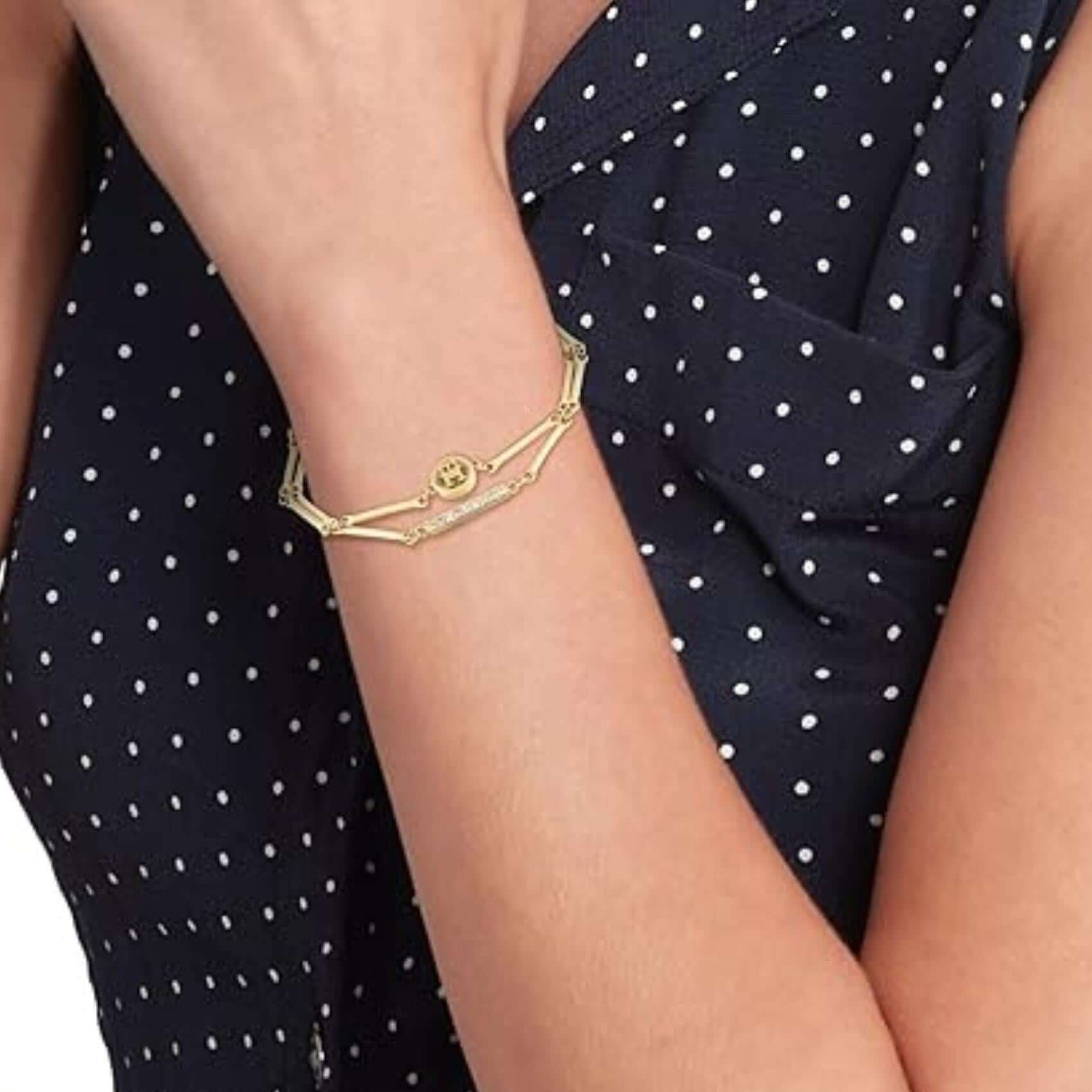 Γυναικείο βραχιόλι Tommy Hilfiger 2781000 φορεμένο στον καρπό, σε χρυσό χρώμα με διπλή αλυσίδα και ζιργκόν.