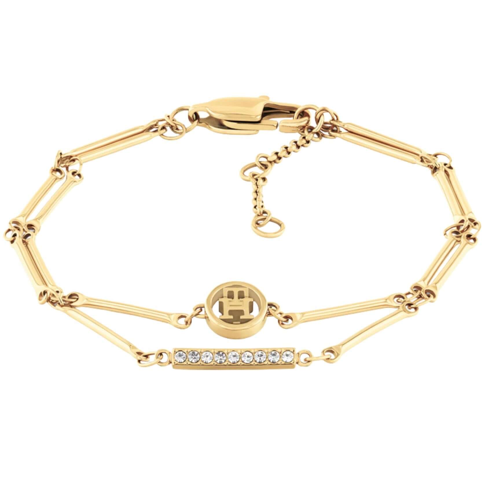 Γυναικείο βραχιόλι Tommy Hilfiger 2781000 από ανοξείδωτο ατσάλι σε χρυσό χρώμα με διπλή αλυσίδα, λογότυπο και ορθογώνια μπάρα με ζιργκόν.