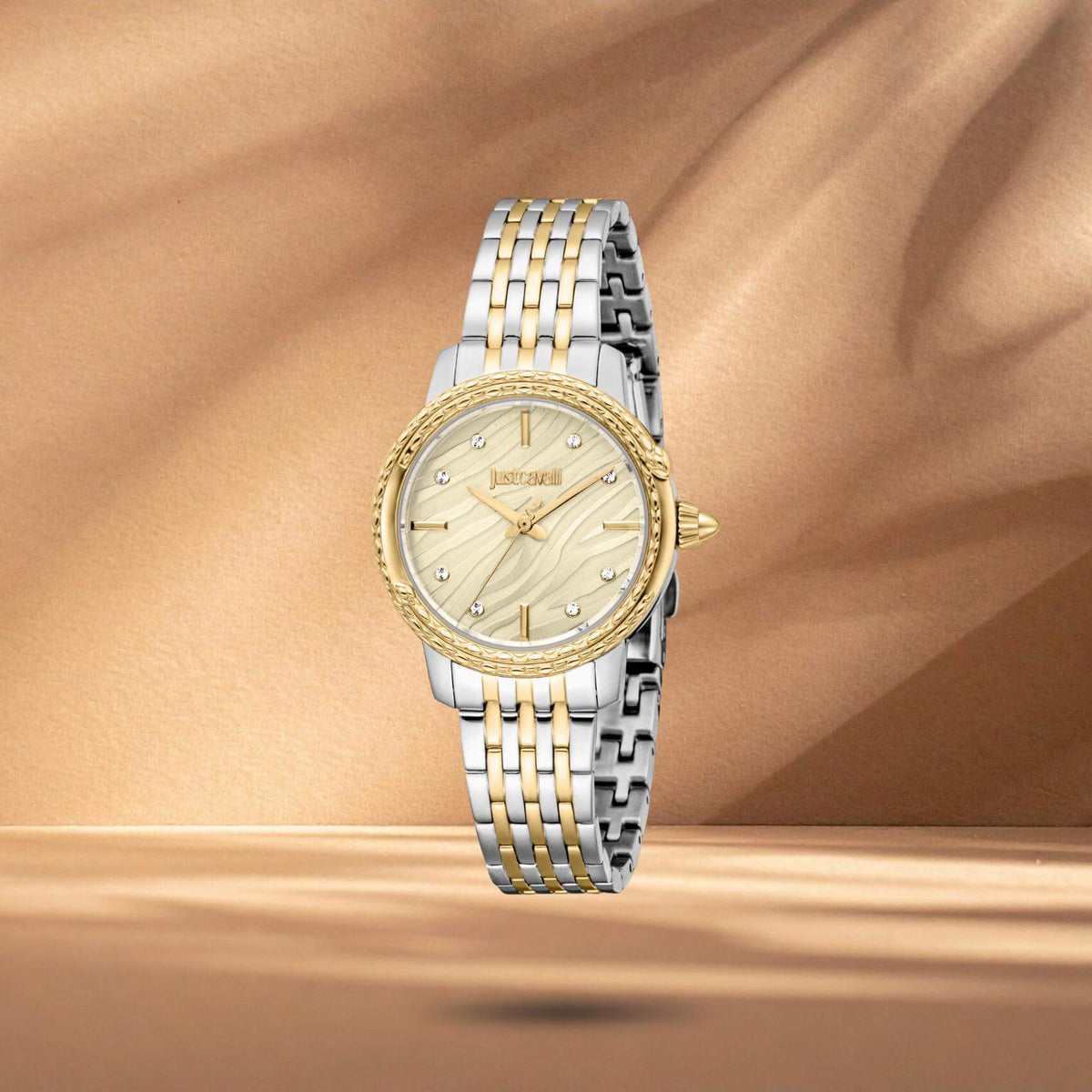 Just Cavalli JC1L336M0085 γυναικείο ρολόι με δίχρωμο ατσάλινο μπρασελέ σε ασημί και χρυσό χρώμα, σαμπανί καντράν διαμέτρου 30mm, λαμπερά ζιργκόν και στεφάνι με φίδια.