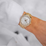 Γυναικείο ρολόι Michael Kors Liliane MK4555 με ατσάλινο μπρασελέ σε χρυσό χρώμα, στρογγυλό άσπρο φίλντισι καντράν και στεφάνι 36mm με ζιργκόν.