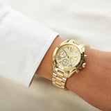 Γυναικείο ρολόι Michael Kors Mini Bradshaw MK5798 χρονογράφος με ατσάλινο μπρασελέ σε χρυσό χρώμα, στρογγυλό χρυσό καντράν με ημερομηνία και στεφάνι 36mm.