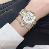 Γυναικείο ρολόι Michael Kors Taryn MK6550 με ατσάλινο μπρασελέ σε χρυσό χρώμα, στρογγυλό άσπρο καντράν και στεφάνι 40mm με ζιργκόν.