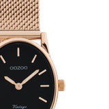 Οβάλ ρολόι Oozoo Vintage C20260 με ροζ χρυσό ατσάλινο μπρασελέ, μαύρο καντράν διαστάσεων 28Χ22mm και μηχανισμό μπαταρίας quartz.