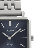 Τετράγωνο ρολόι Oozoo Vintage C9951 με ασημί ατσάλινο μπρασελέ,μπλε καντράν 29x29mm και μηχανισμό μπαταρίας quartz.