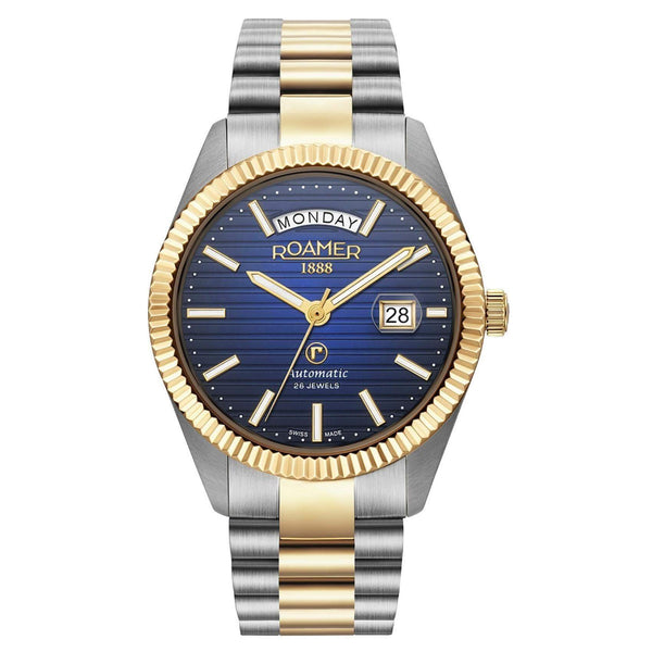 Αυτόματο ρολόι open back Roamer Primeline Day Date II 981666-47-45-50 με δίχρωμο ασημί-χρυσό μπρασελέ, μπλε καντράν με ένδειξη ημέρας και ημερομηνίας και κάσα διαμέτρου 42mm.