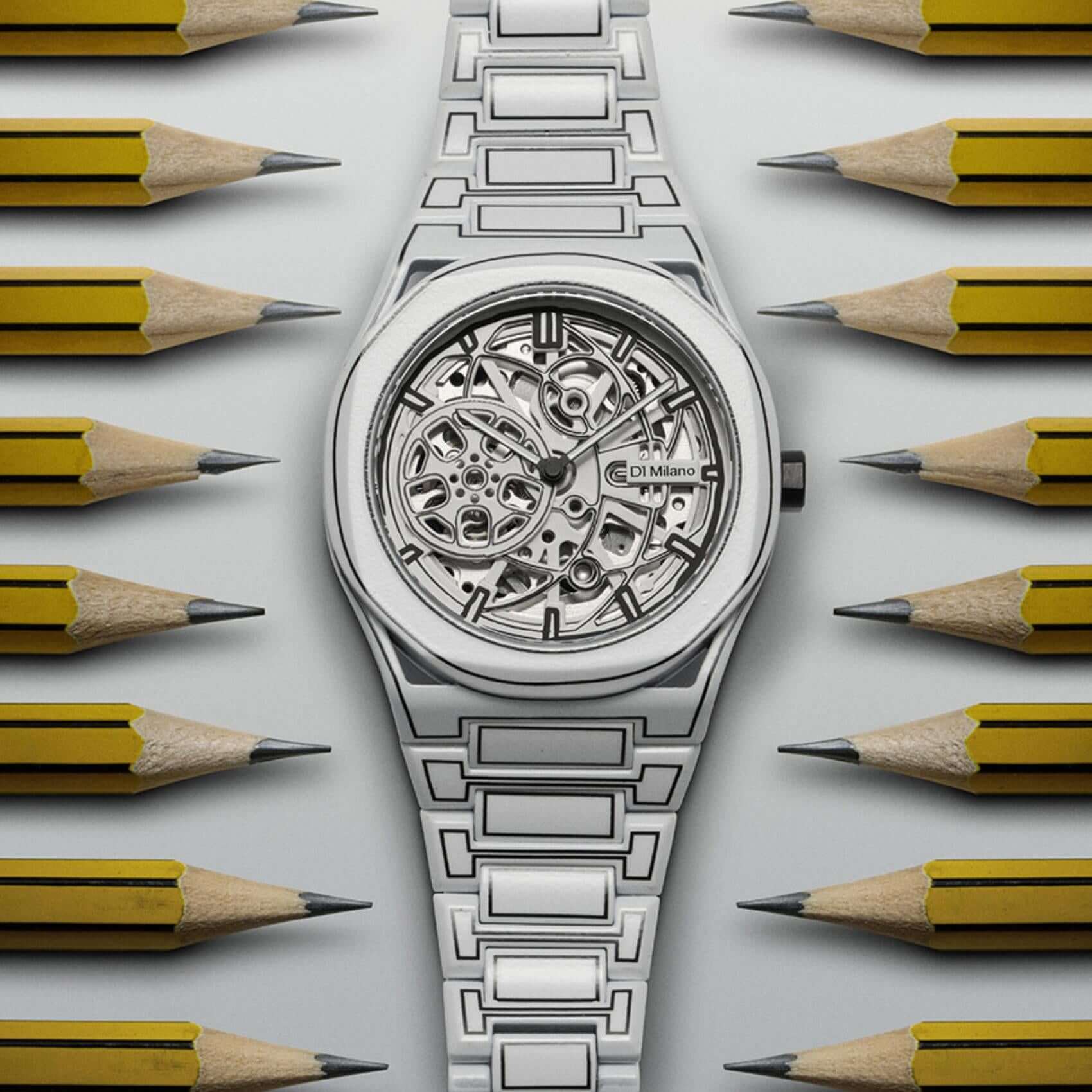Ανδρικό ρολόι D1 Milano Skeleton White Sketch D1-SKBJ20 με άσπρο ατσάλινο μπρασελέ, άσπρο skeleton καντράν 40.5mm σε φόντο με μολύβια.