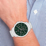 Ανδρικό ρολόι Tommy Hilfiger Henry 1710686 με ασημί ατσάλινο μπρασελέ και σκούρο πράσινο καντράν διαμέτρου 43mm, φορεμένο.