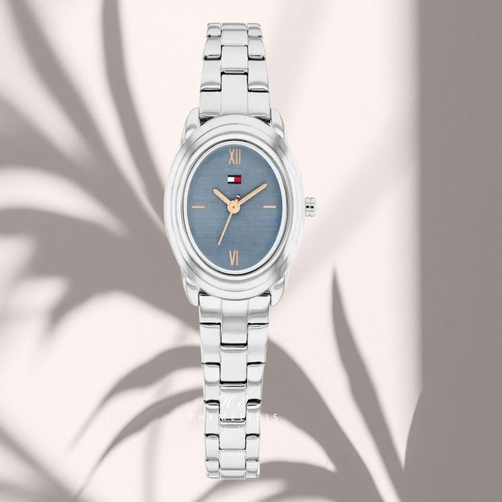 Γυναικείο ρολόι Tommy Hilfiger Demi 1782873 με μπλε οβάλ καντράν με διάσταση 19.7mm, χρυσούς δείκτες και ασημί μπρασελέ.