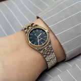 Γυναικείο ρολόι Tommy Hilfiger Rachel 1782549 με δίχρωμο ασημί-χρυσό ατσάλινο μπρασελέ και μαύρο καντράν διαμέτρου 34mm.