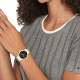 Γυναικείο ρολόι Tommy Hilfiger Monica 1782591, με δίχρωμο μπρασελέ σε ασημί-χρυσό χρώμα από ανοξείδωτο ατσάλι και μαύρο καντράν με χρονογράφους φορεμένο σε γυναικείο χέρι.