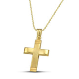 Χρυσός σταυρός 14 καρατίων με γυαλιστερή επιφάνεια. Γυναικείο  χειροποίητο κόσμημα, φορεμένο σε λεπτή αλυσίδα.