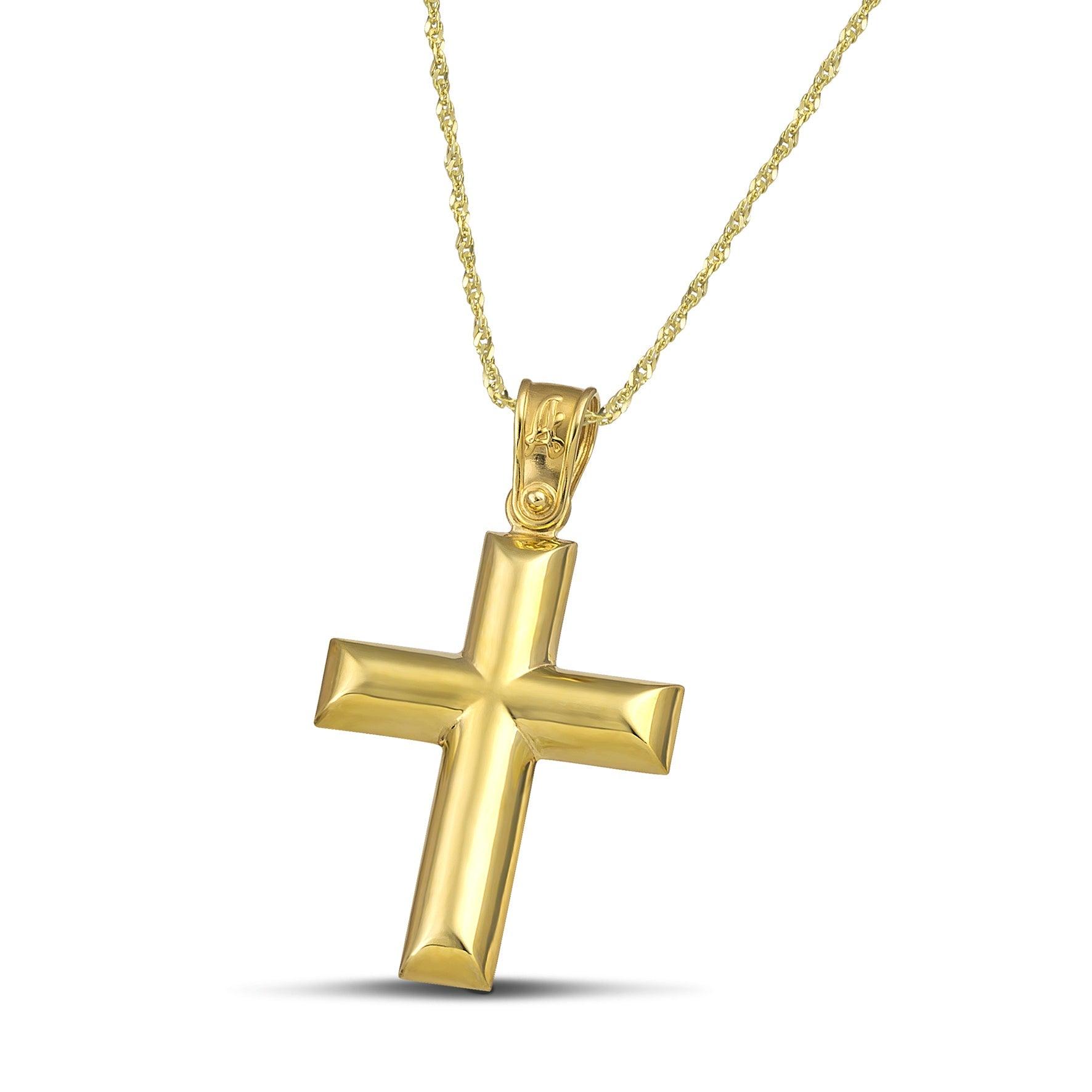 Κλασσικός σταυρός από χρυσό Κ14 για γυναίκα, φορεμένος σε λεπτή , στριφτή αλυσίδα.