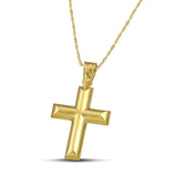 Κλασσικός σταυρός από χρυσό Κ14 για γυναίκα, φορεμένος σε λεπτή , στριφτή αλυσίδα.