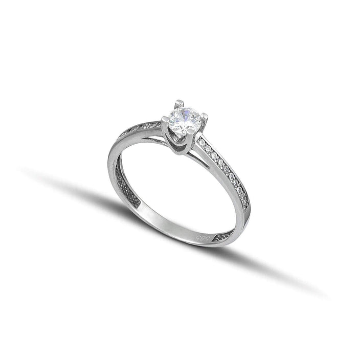 Μονόπετρο δαχτυλίδι λευκόχρυσο Κ14 με πλαϊνές πέτρες.