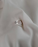 Φωτογραφία μονόπετρου δαχτυλιδιού OS007 από λευκόχρυσο 14Κ με ζιργκόν στο πλάι, που αναδεικνύει το προφίλ του δαχτυλιδιού, το δέσιμο της πέτρας και τις πλαϊνές λεπτομέρειες για σταθερό κράτημα και καθαρό, φωτεινό αποτέλεσμα.