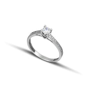 Μονόπετρο δαχτυλίδι λευκόχρυσο Κ14 με πλαϊνές πέτρες.