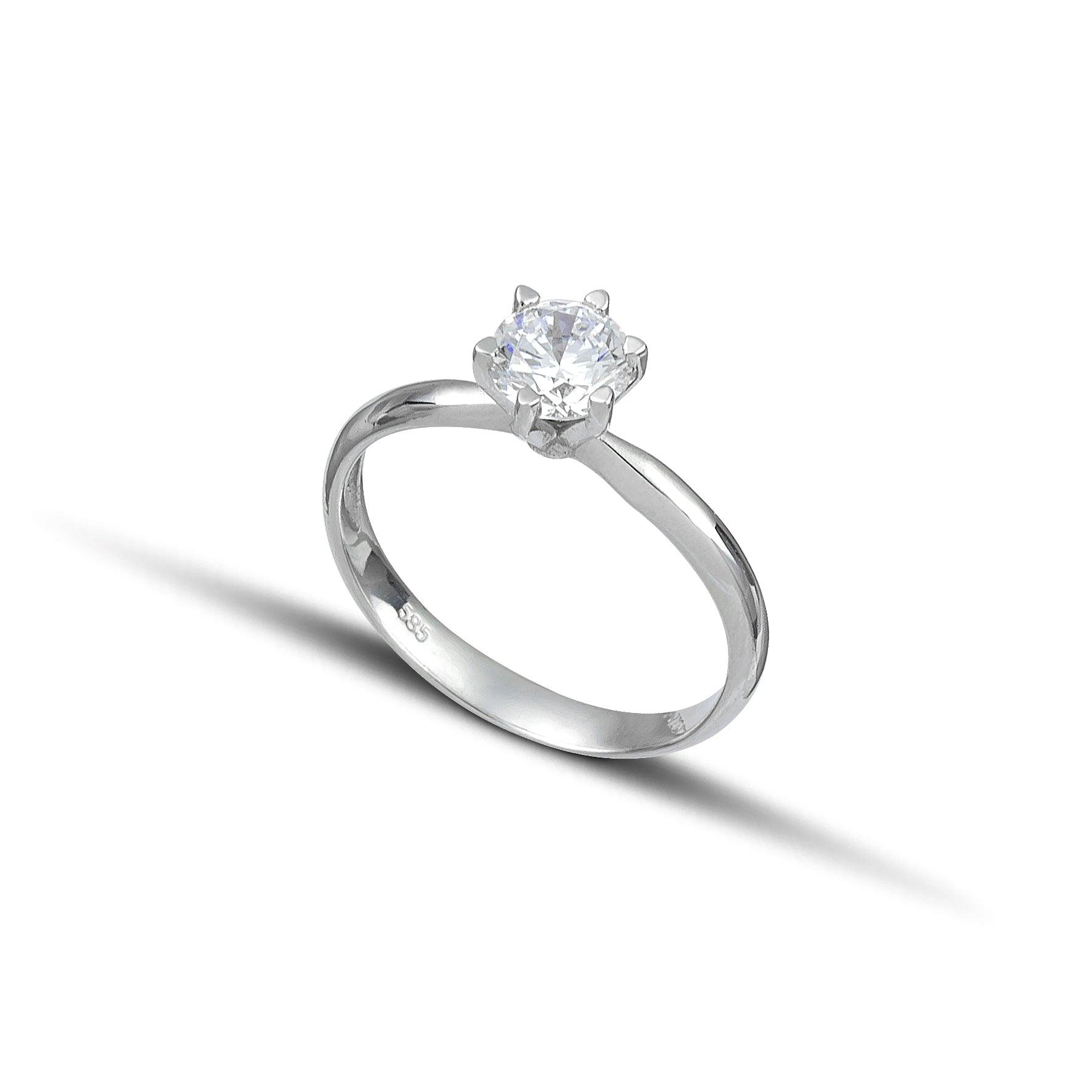 Λευκόχρυσο μονόπετρο δαχτυλίδι με διαμάντι και εξάδοντο καστόνι.
