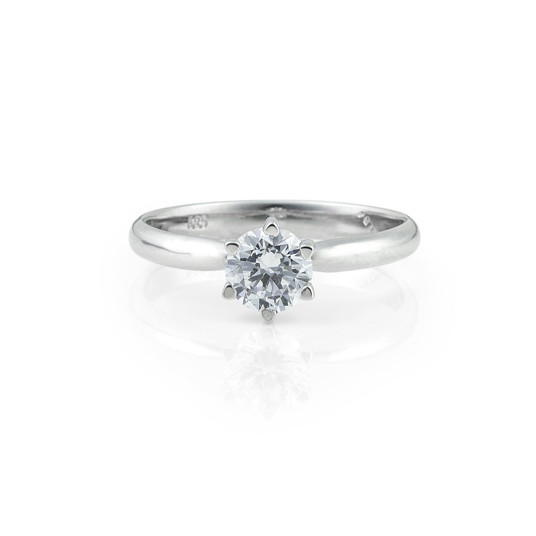 Λευκόχρυσο μονόπετρο δαχτυλίδι με διαμάντι και εξάδοντο καστόνι.